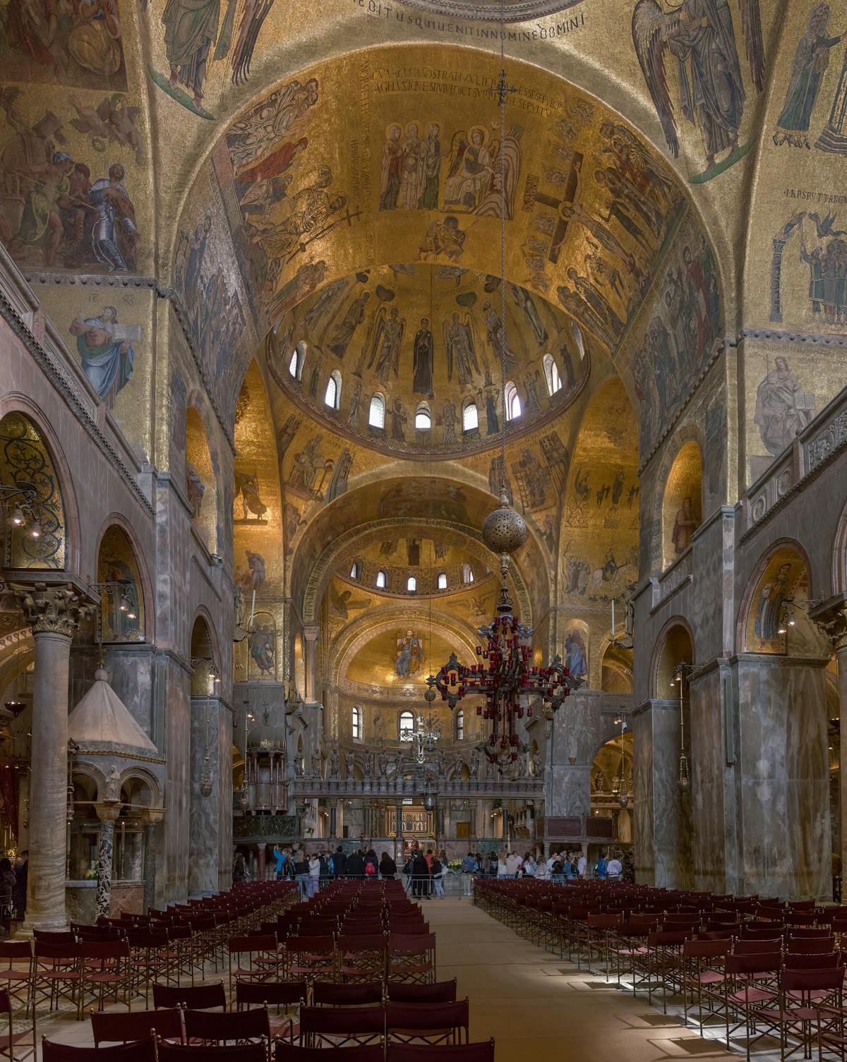 Wide interior view of St Marks Basilica Venice showing ornate mosaics and architecture