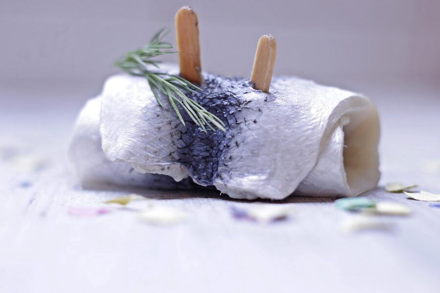 Pickled herring rollmops with dill