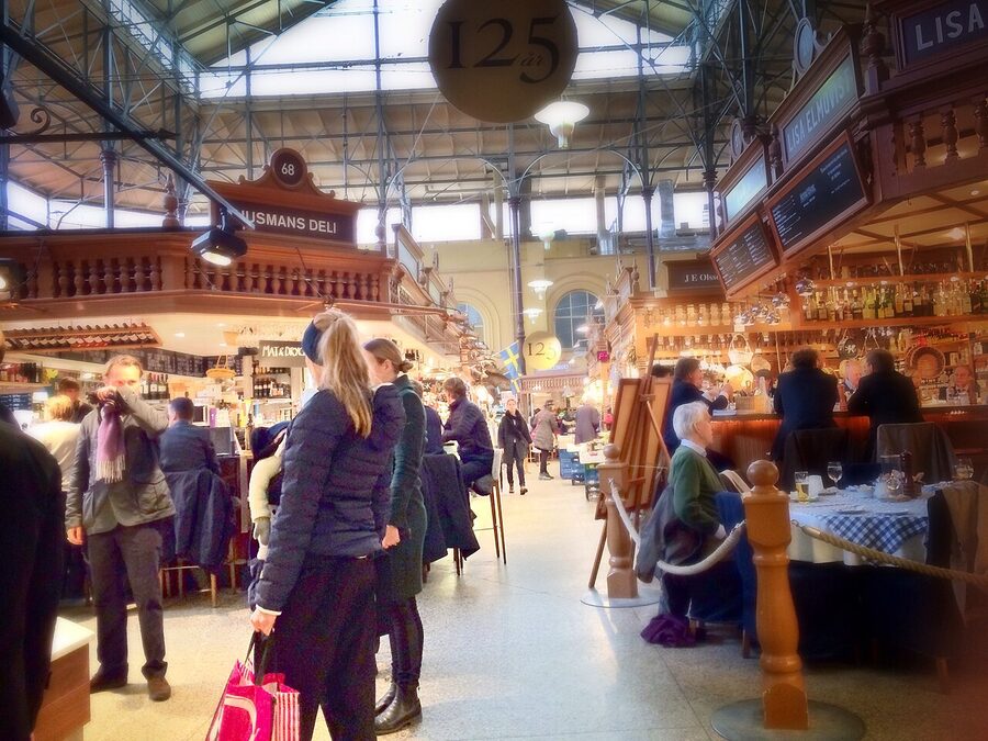 Counter and shoppers inside Östermalms Saluhall Stockholm