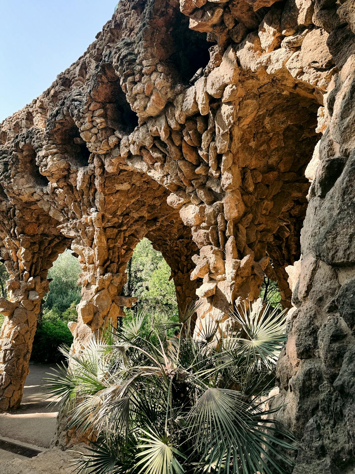 Intricate stone archways designed by Gaudi in Park Guell Barcelona