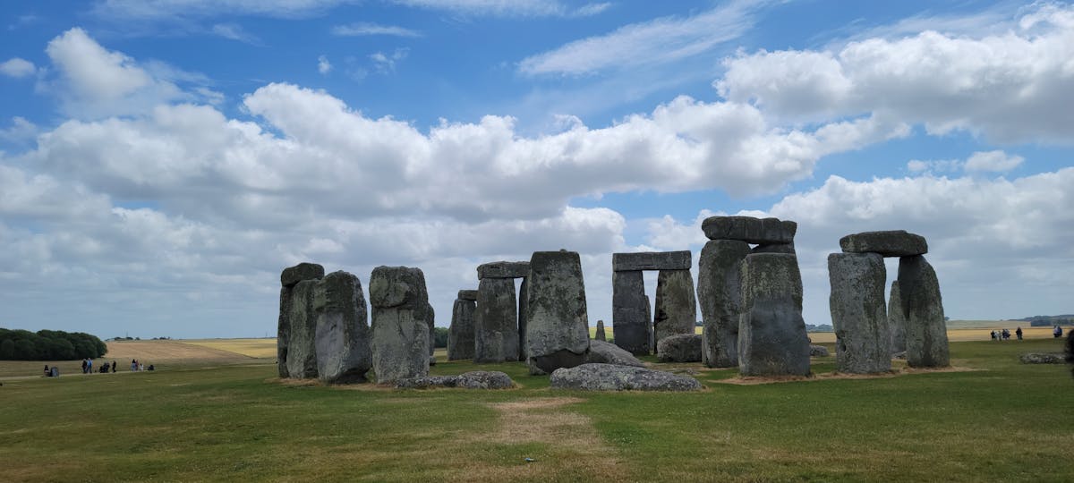 Stonehenge ancient monument under bright cloud-filled sky