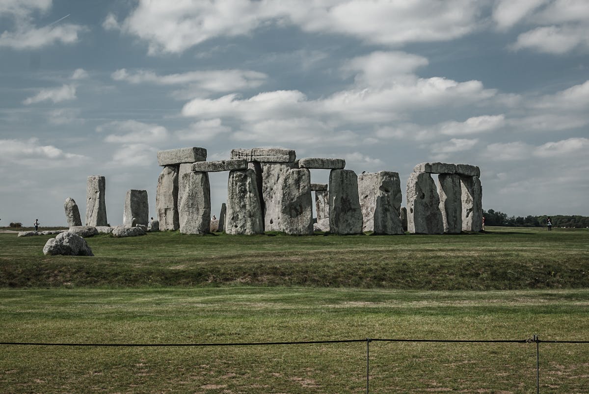 Stonehenge monument in England with lush green grass and dramatic sky