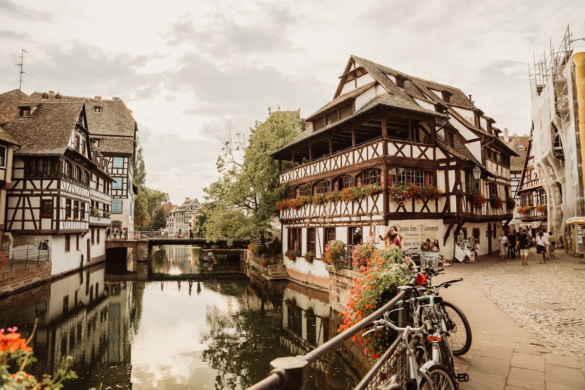 Historic Strasbourg canal lined with half-timbered houses and cobblestone walkways