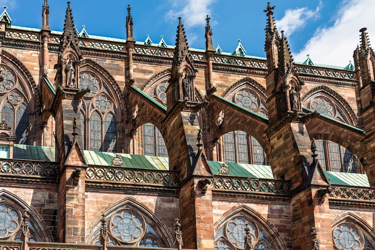 Gothic architecture detail of Strasbourg Cathedral under blue sky