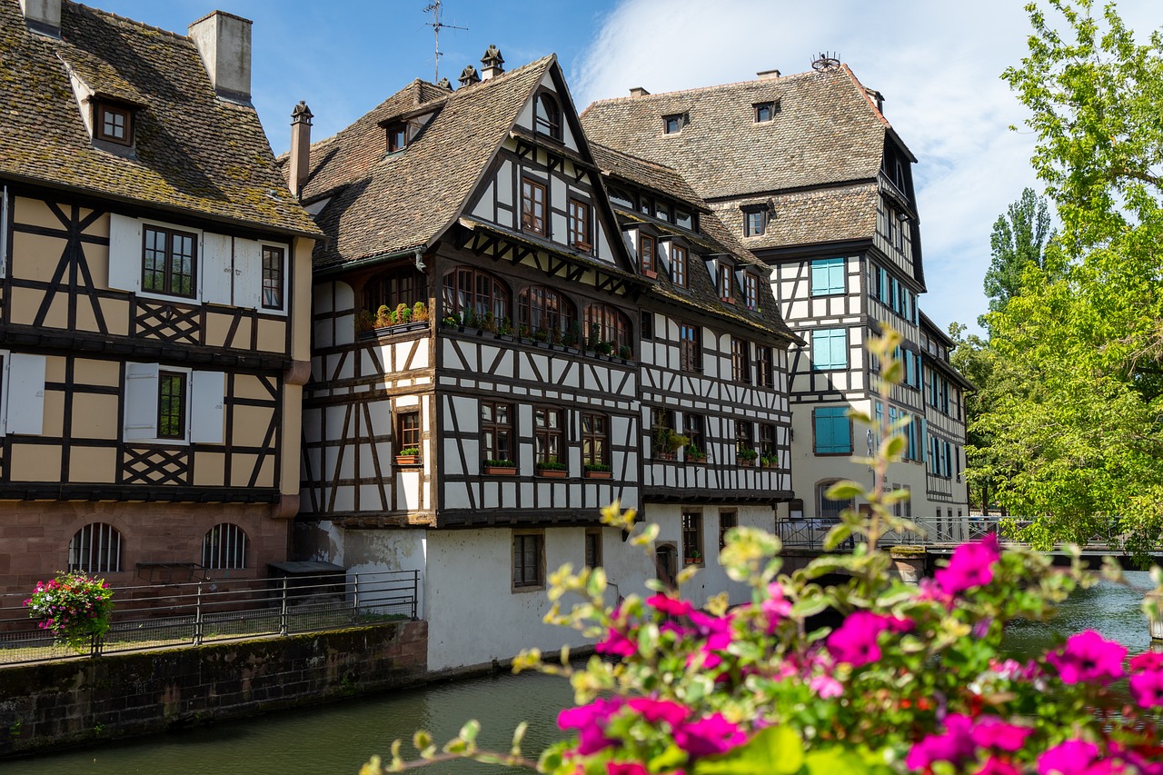 Traditional half-timbered buildings reflecting in Strasbourg canal