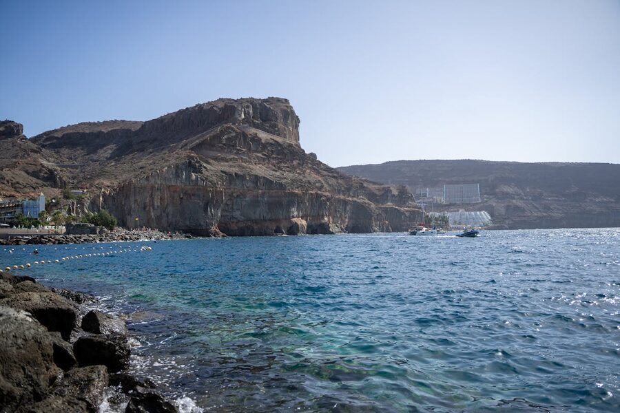 Scenic Mogan coastline with rocky cliffs under blue sky in Gran Canaria