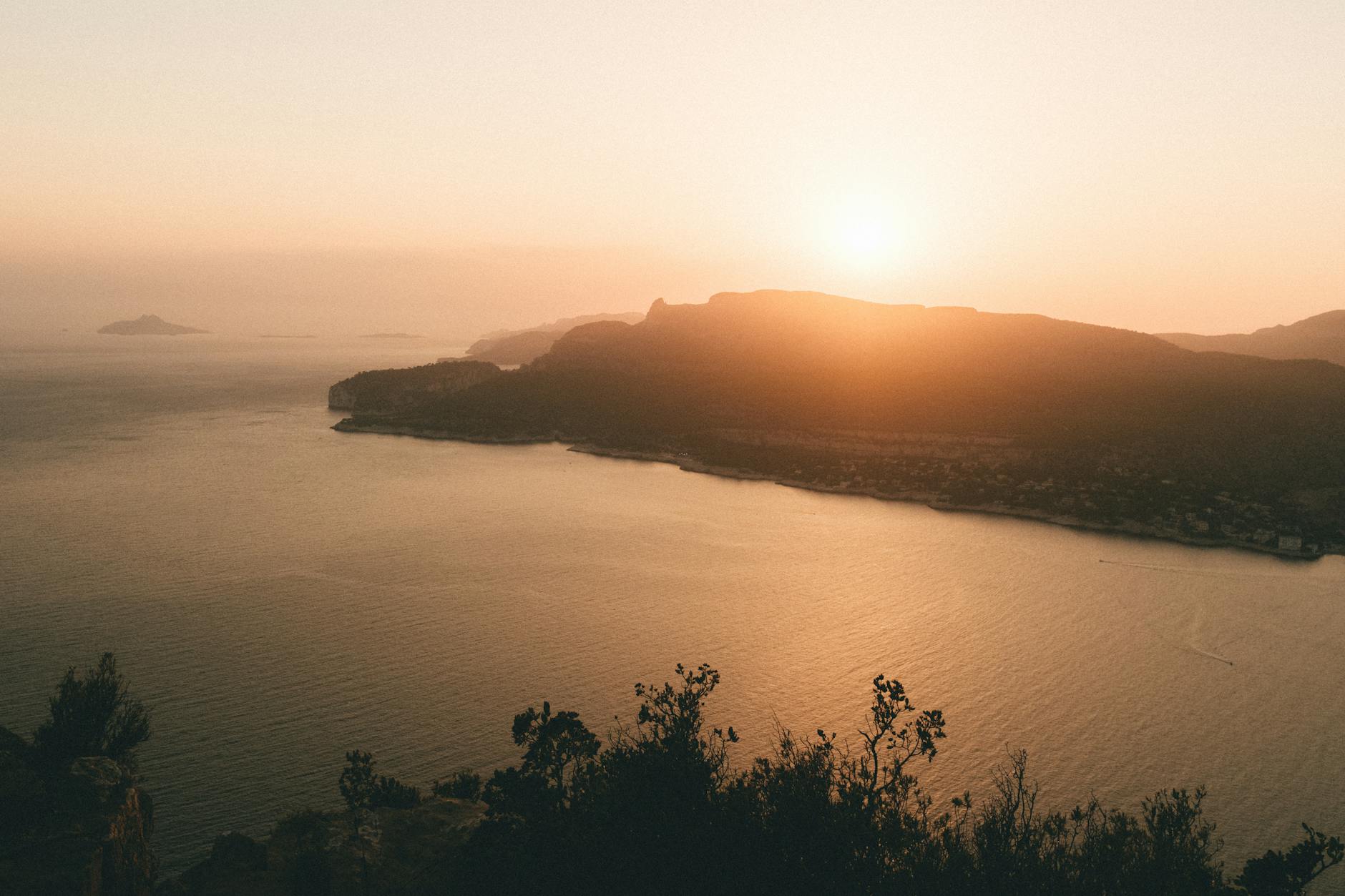 Golden sunset light over rocky Mediterranean coastline near Cassis in Provence