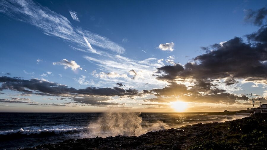 Golden sunset casting warm light over the sea and coastline at Nerja in Malaga province