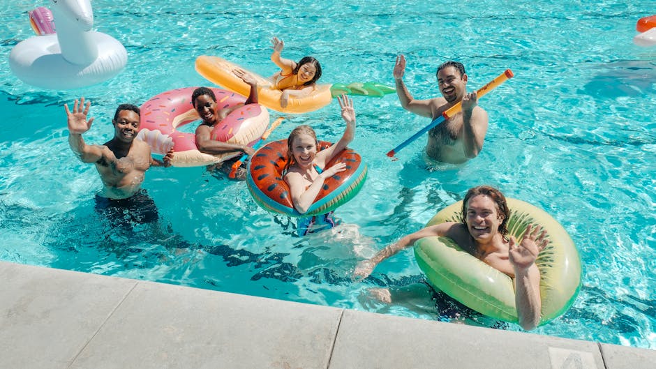 People enjoying themselves swimming in a pool on a sunny day