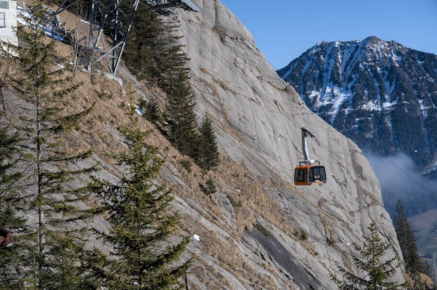 Cable car traversing rocky cliff Switzerland