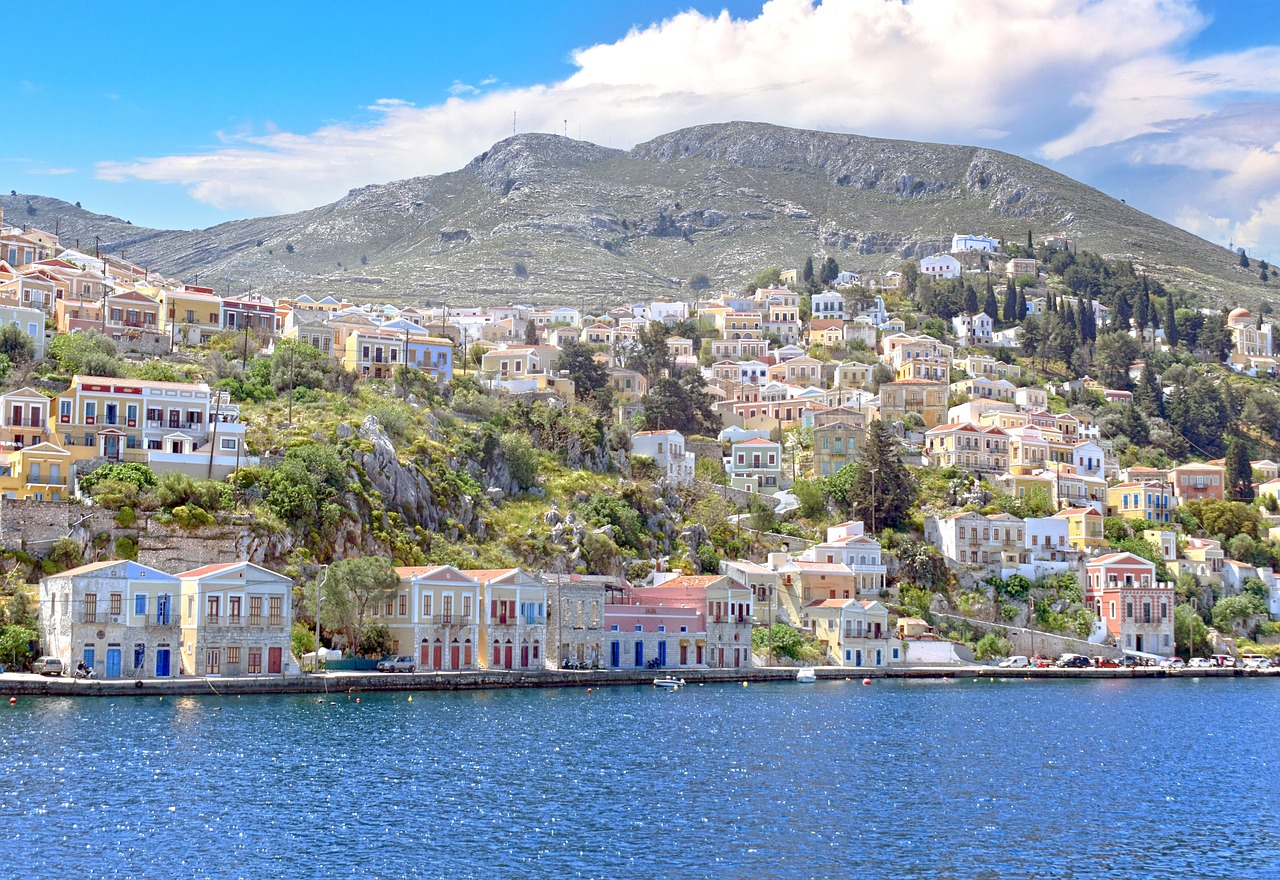 Symi island with colourful houses on a hillside in morning light