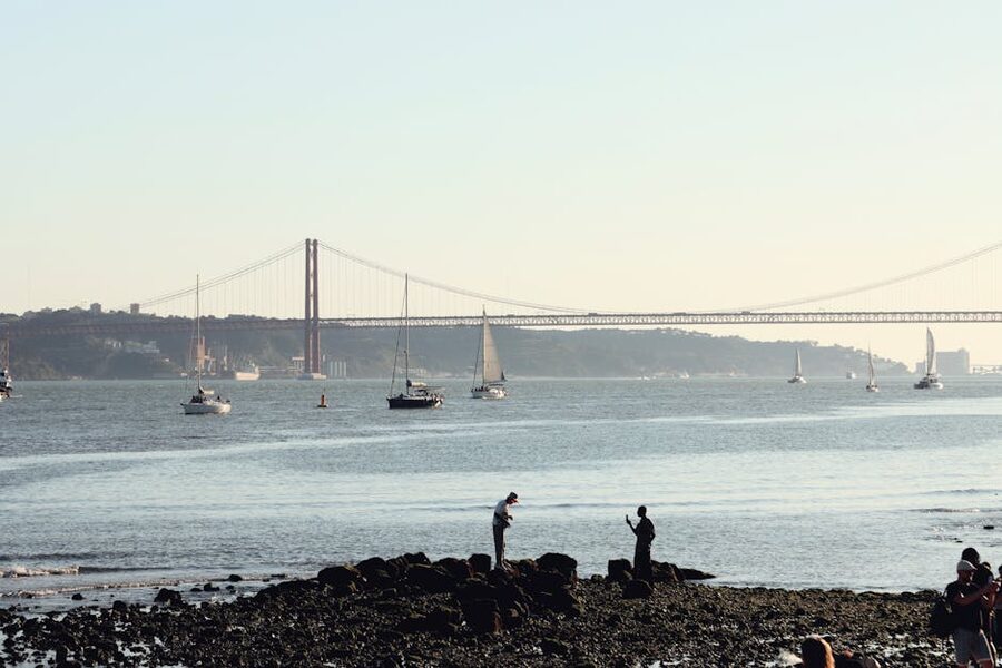 Sailboats on the Tagus River near 25 de Abril Bridge in Lisbon