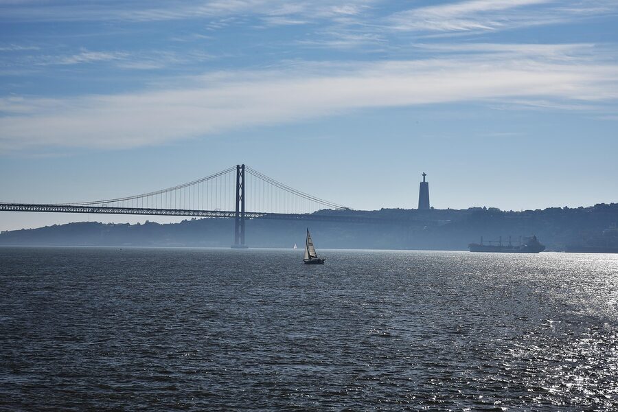 Sailing boat on the Tagus River with the 25 de Abril Bridge