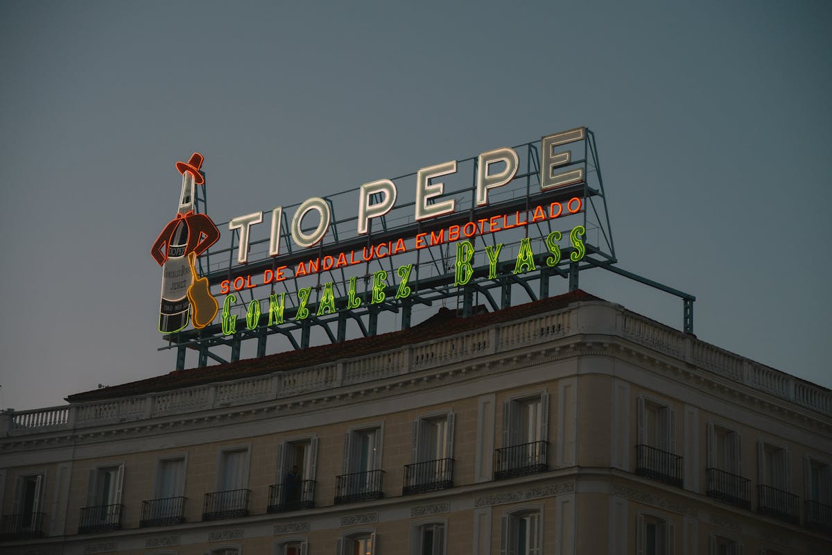 The iconic Tio Pepe sign at Puerta del Sol in Madrid at dusk