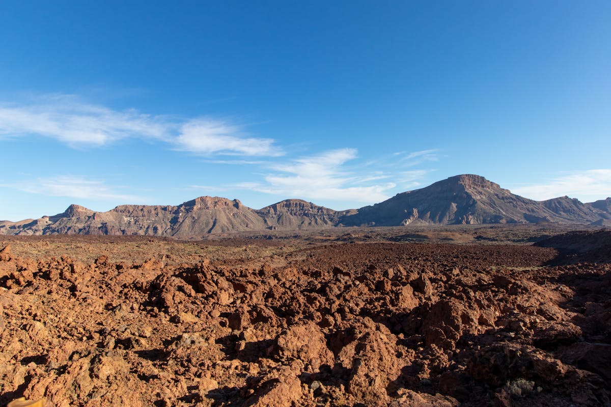 Rugged volcanic terrain of the Teide caldera under clear blue sky in Tenerife Spain