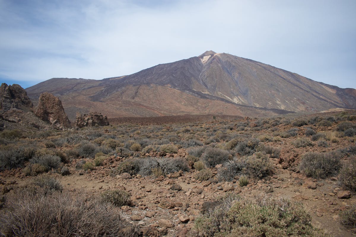 Rocky volcanic terrain of Mount Teide under clear blue sky in Tenerife