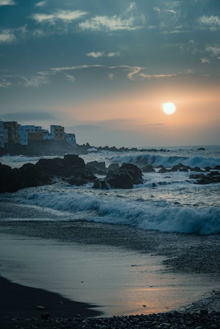A coastal beach scene in Tenerife with blue ocean and clear skies