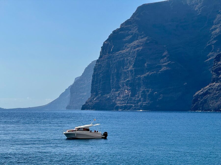 Tour boat cruising near the cliffs of Los Gigantes in Tenerife