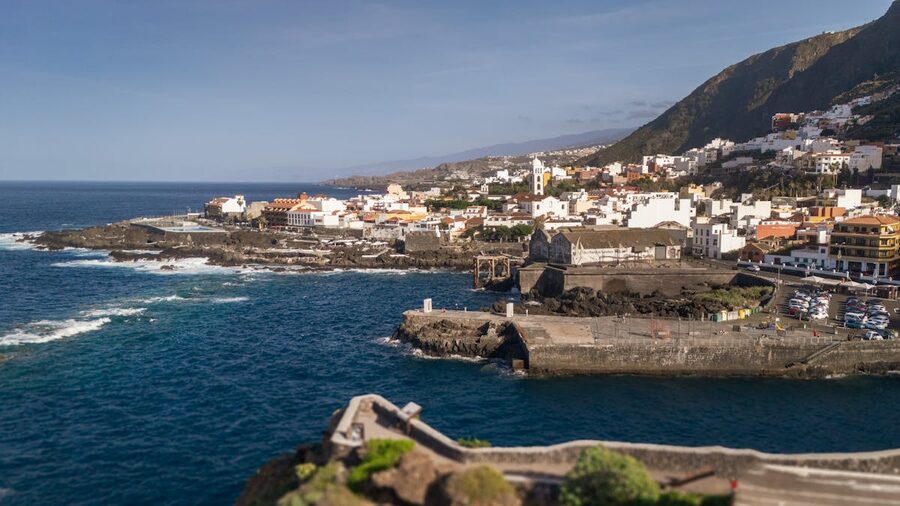 Aerial view of Garachico town along the rugged coastline of Tenerife Spain