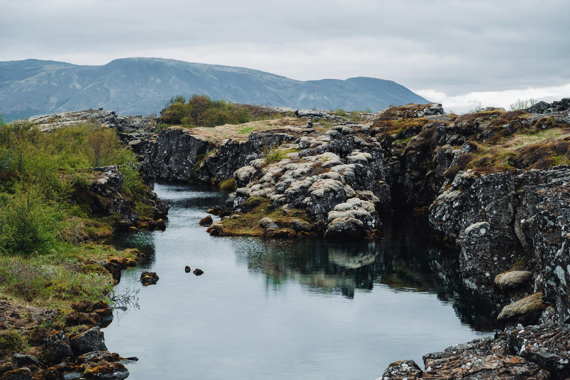 Peaceful river flowing through rocky terrain in Thingvellir National Park Iceland