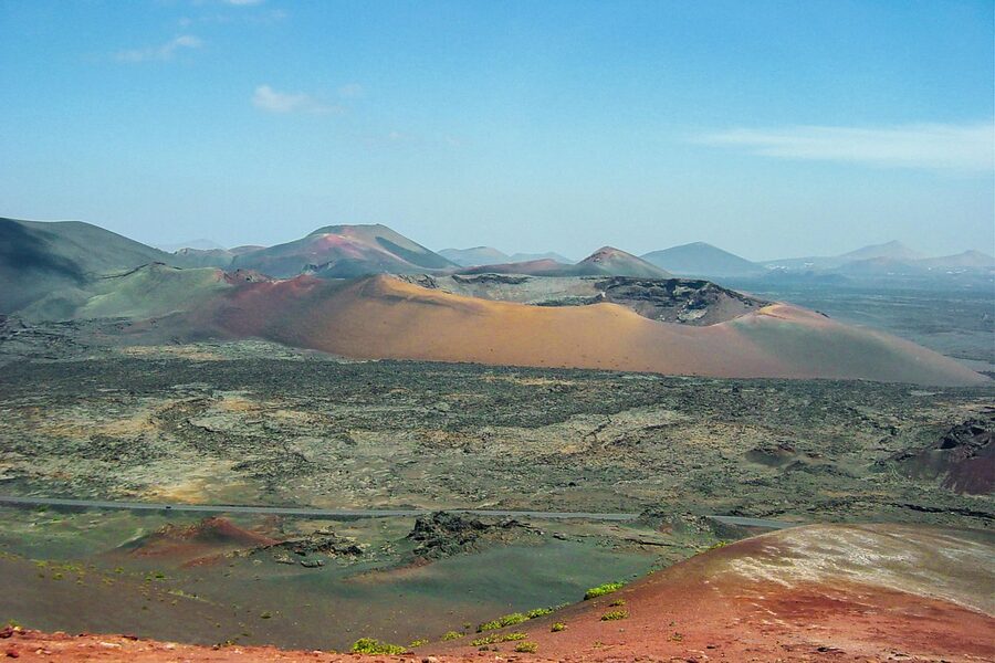 Arid volcanic terrain in Timanfaya National Park with dark lava fields