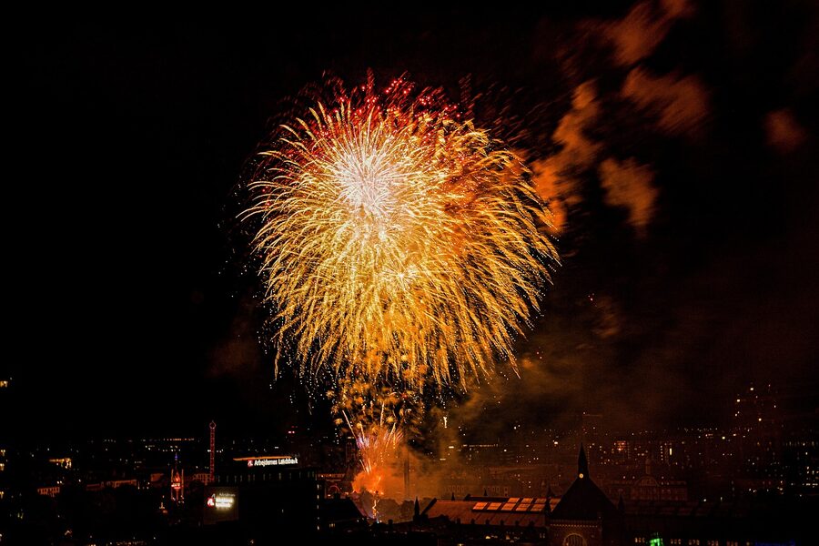 Fireworks display lighting up the sky over Tivoli Gardens in Copenhagen at night