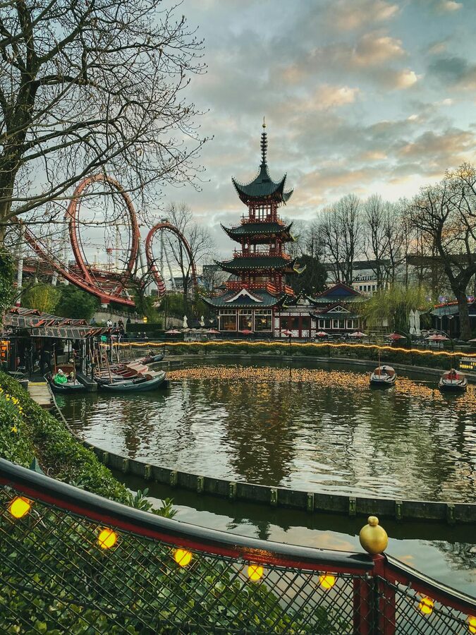 Tivoli Gardens park interior with attractions and visitors in Copenhagen