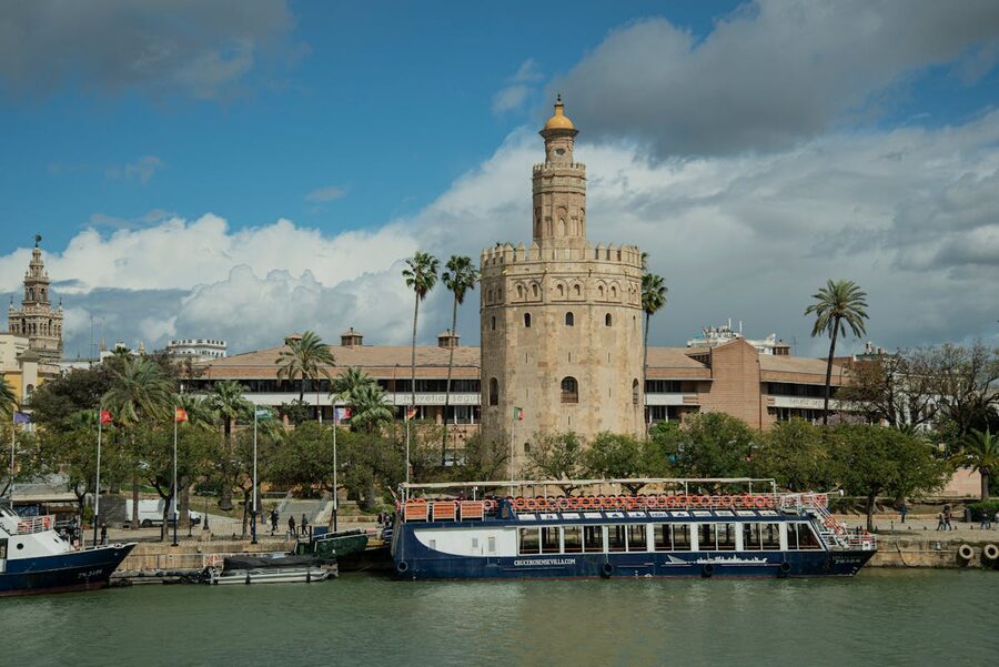 Torre del Oro tower overlooking a boat on the Guadalquivir River in Seville