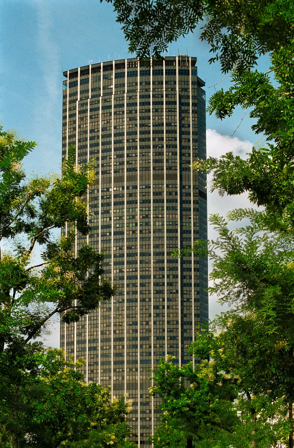 Close view of Tour Montparnasse surrounded by classic Parisian buildings