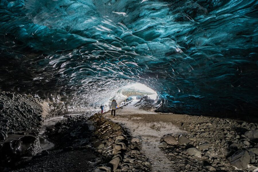 Tourists exploring Icelandic ice cave interior