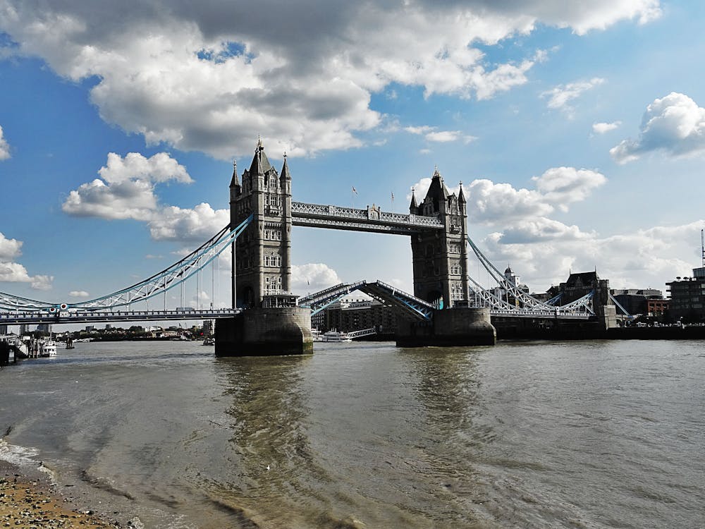 Tower Bridge in London with its bascules raised allowing a ship to pass through