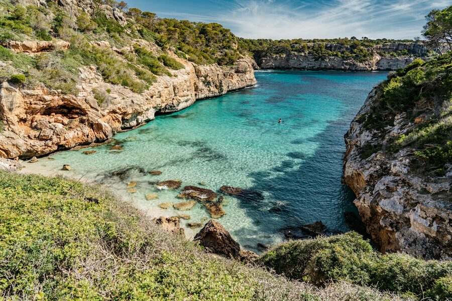 Tranquil bay with clear turquoise waters and rugged cliffs