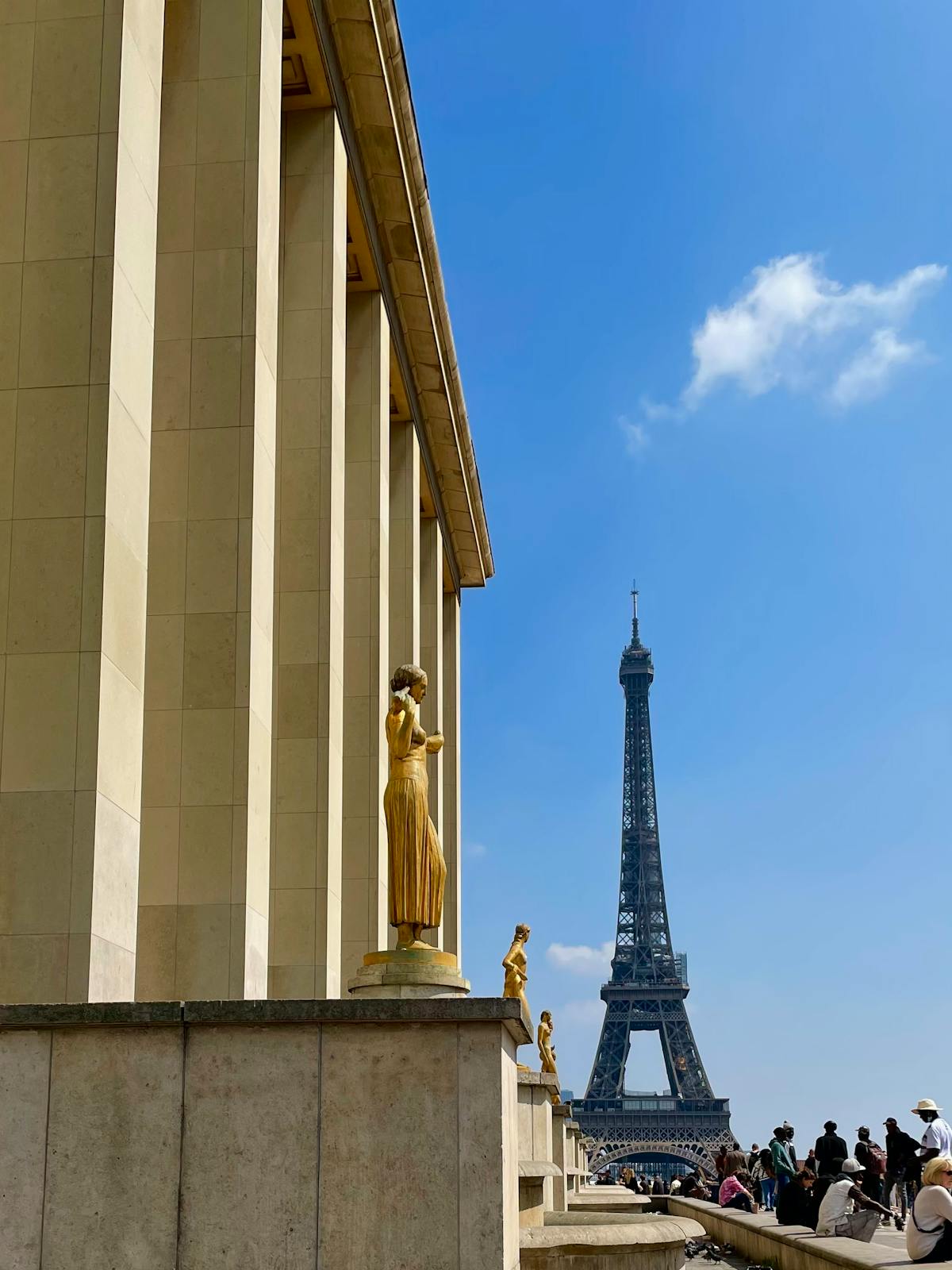 Golden statues at Trocadero with the Eiffel Tower looming in the background