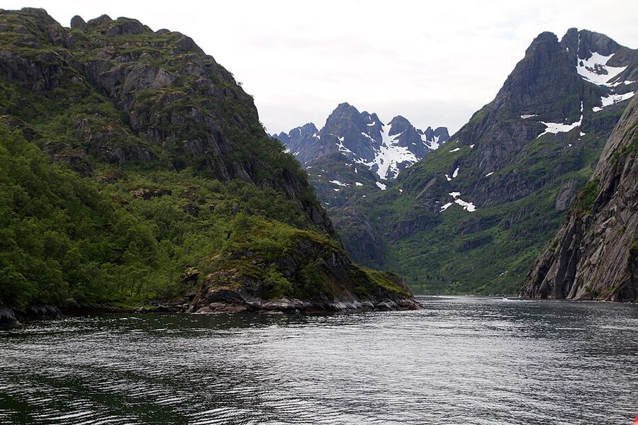 Steep mountain walls of Trollfjord rising vertically from the water