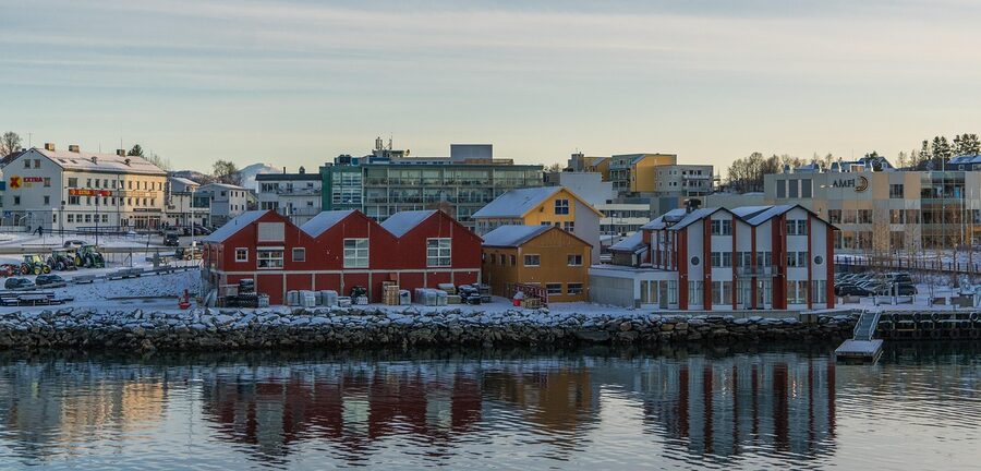 Tromso coast with reflection in calm fjord water
