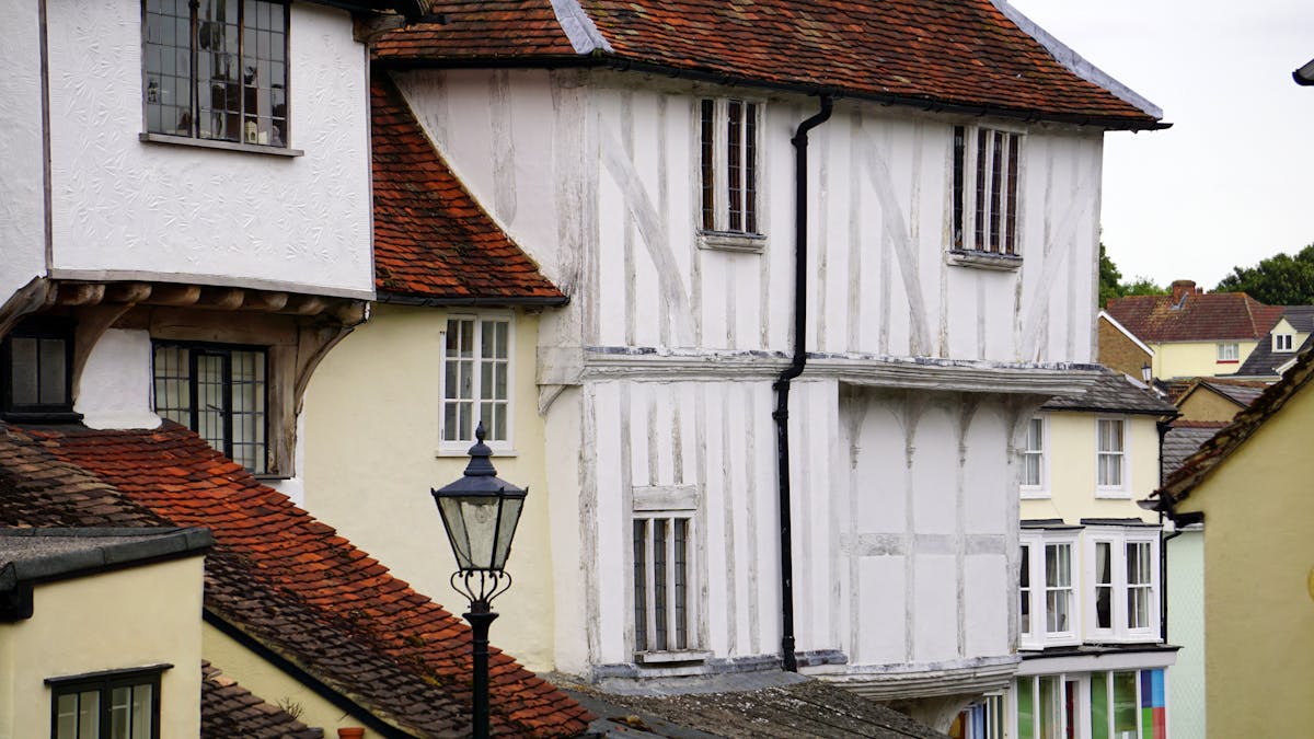 Row of historic buildings with distinct Tudor-era architectural details in England