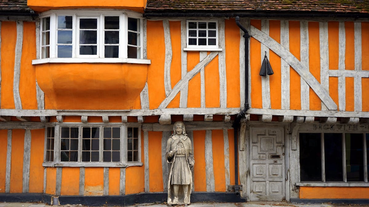Colourful Tudor-style house facade with distinctive wooden beams and decorative details