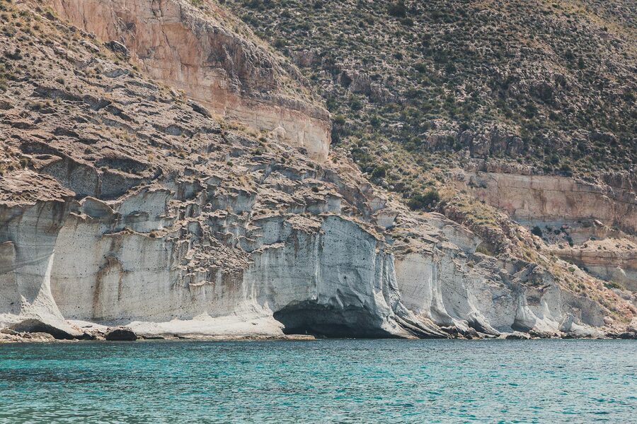 Rocky cliffs along turquoise waters of the Almeria coastline