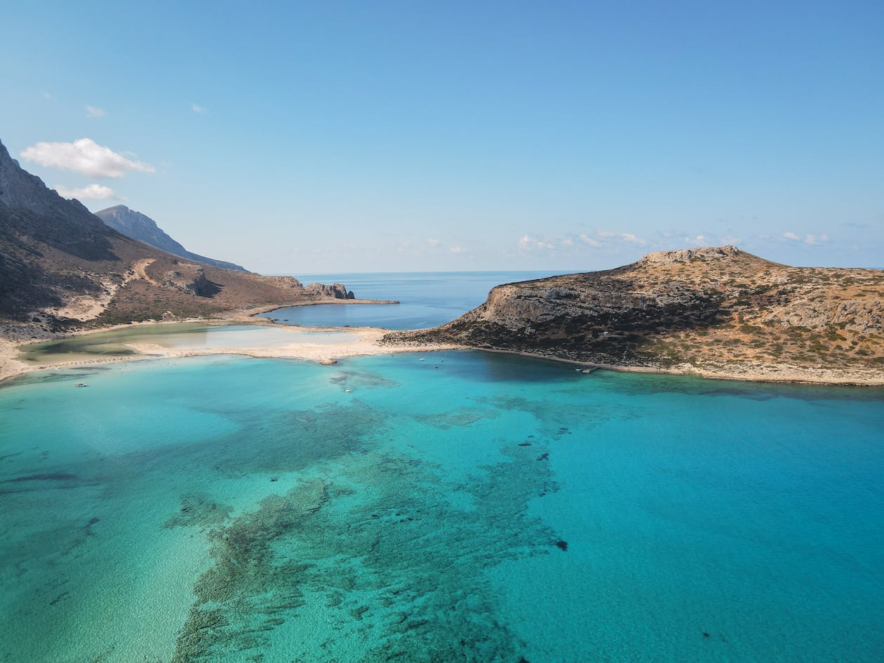 Turquoise lagoon and rugged island coastline from above
