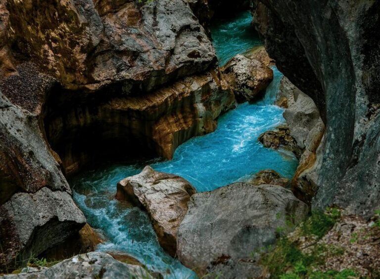 Turquoise river waters flowing through a narrow rock gorge
