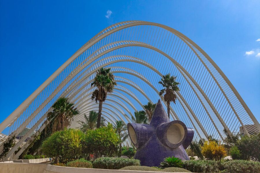 Lush gardens under the architectural arches of L'Umbracle in Valencia