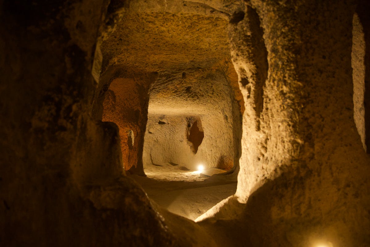 Ancient underground passage with textured stone walls and dim lighting