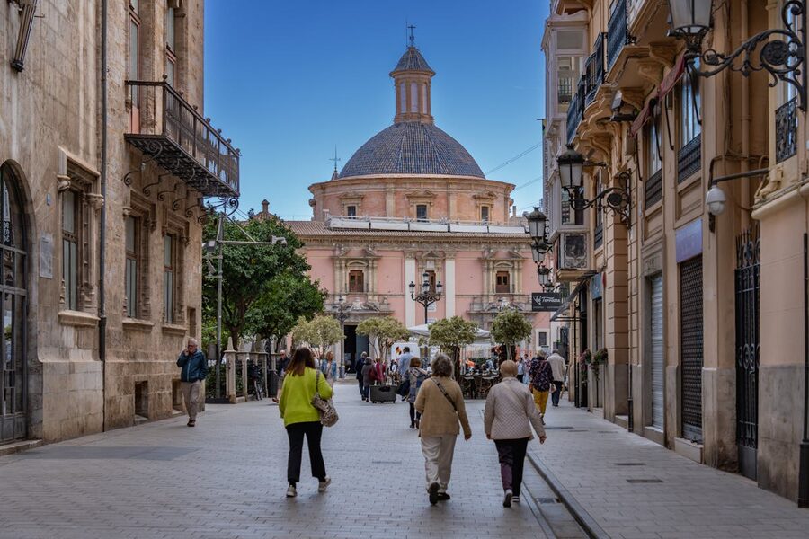Charming historic street in Valencia with people walking