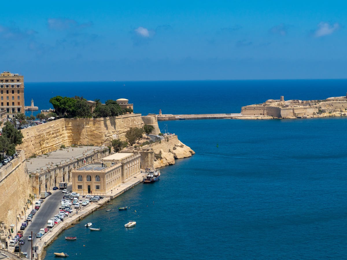 Panoramic view of Valletta harbor with cliffs and azure sea