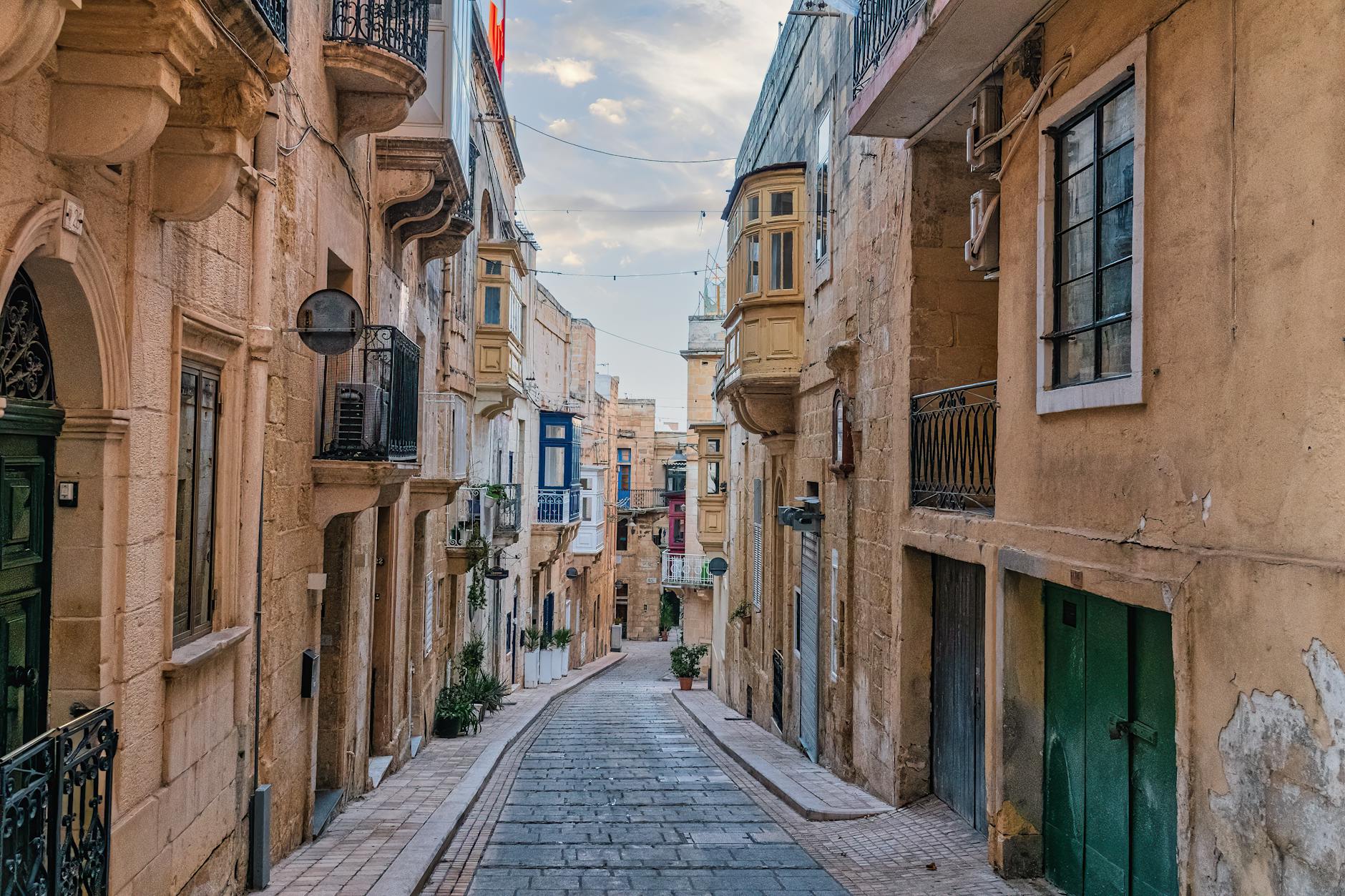 Narrow Valletta street with colourful traditional Maltese balconies