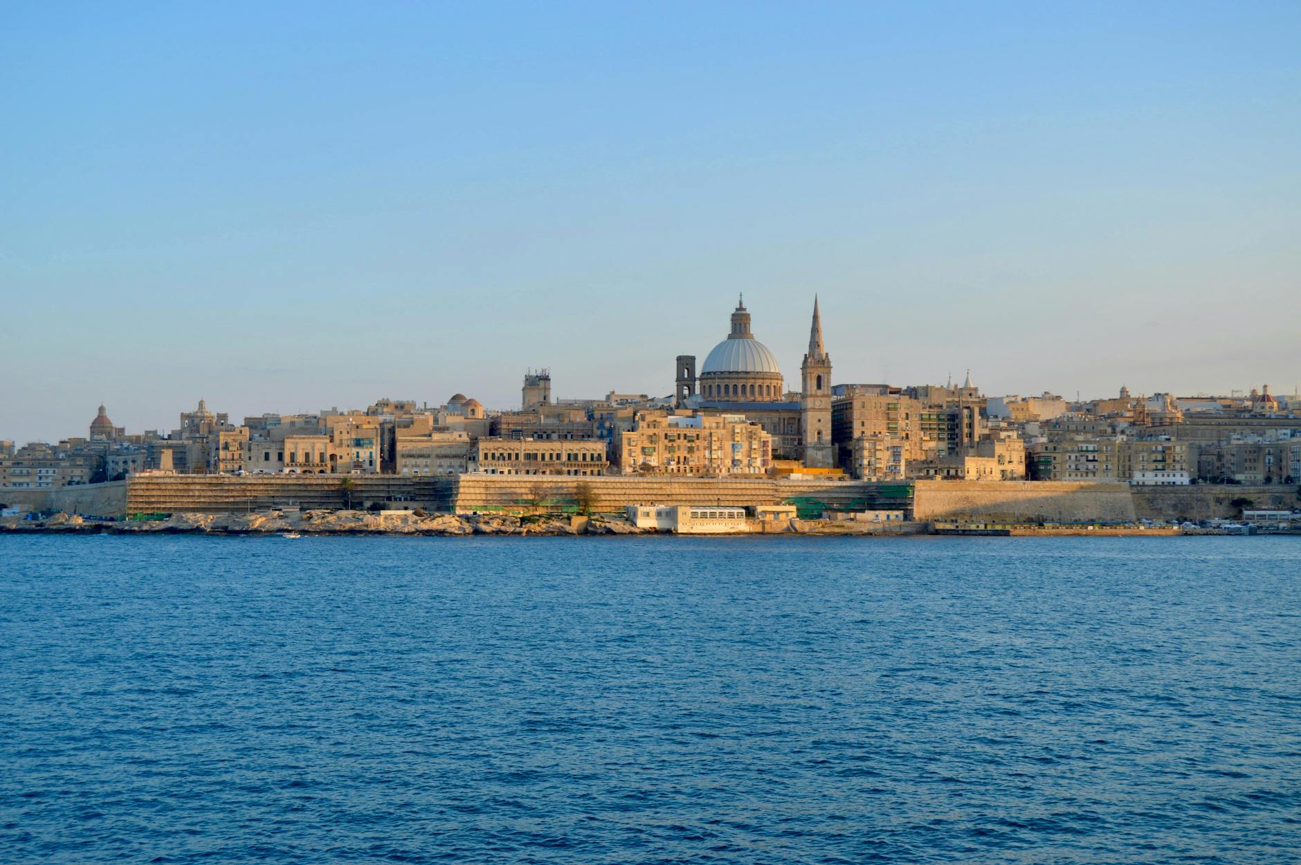 Valletta skyline featuring iconic domes and limestone buildings under clear sky