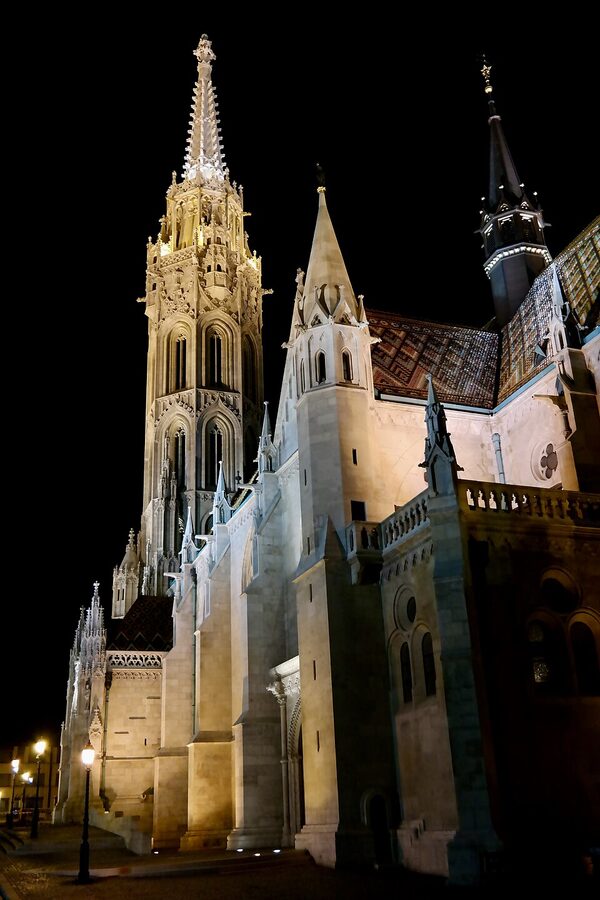 Matthias Church spire illuminated at night Budapest