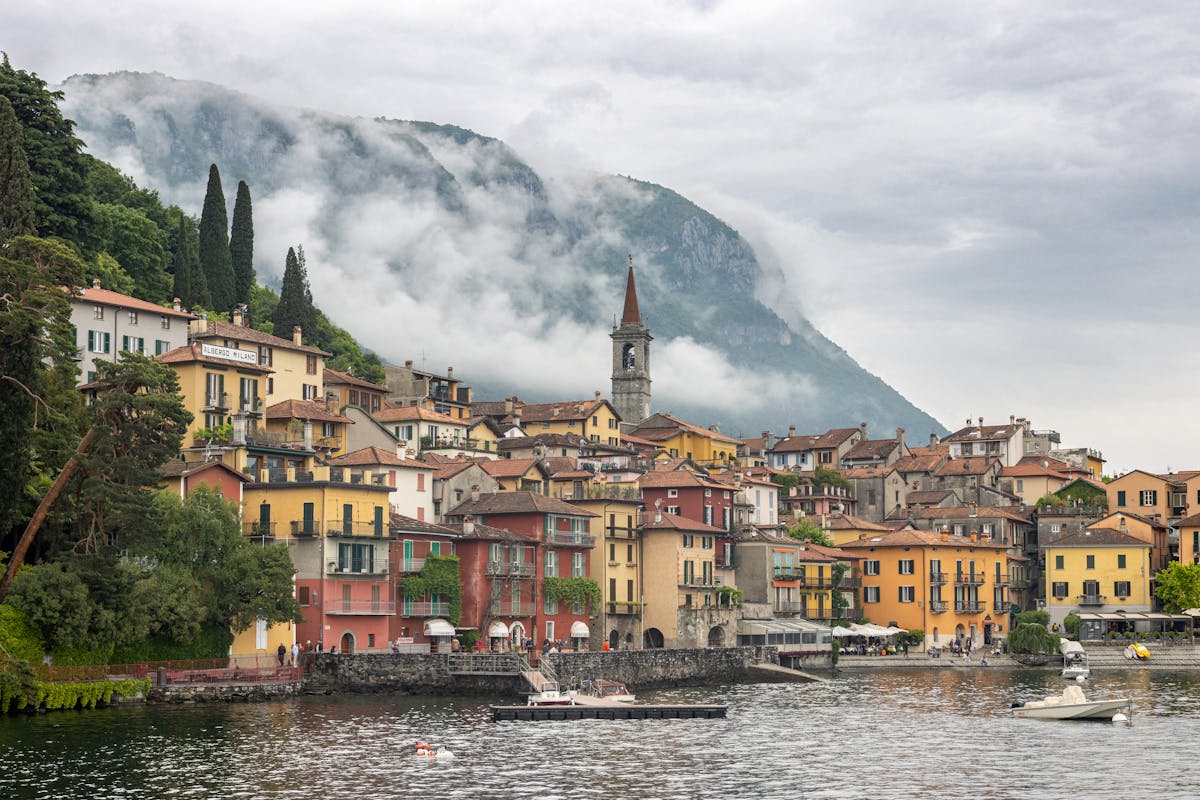Colorful buildings of Varenna on Lake Como with misty mountains