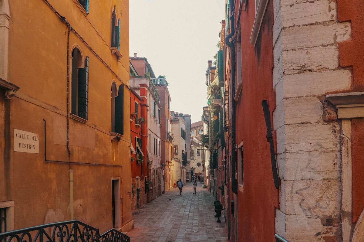 A quiet Venice alley with colorful buildings and a peaceful atmosphere