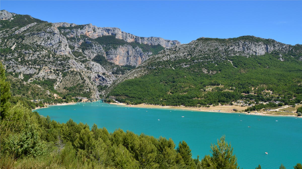 Aerial view of turquoise lake surrounded by green mountains near the Gorges du Verdon in Provence France